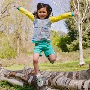 Girl jumping over a log